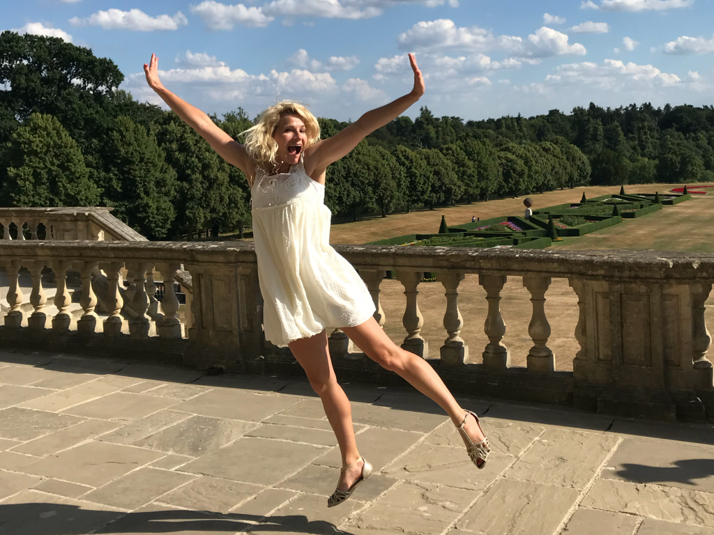 Sweeting’s Greetings artist jumps for joy on balcony of stately home Cliveden National Trust in Berkshire.