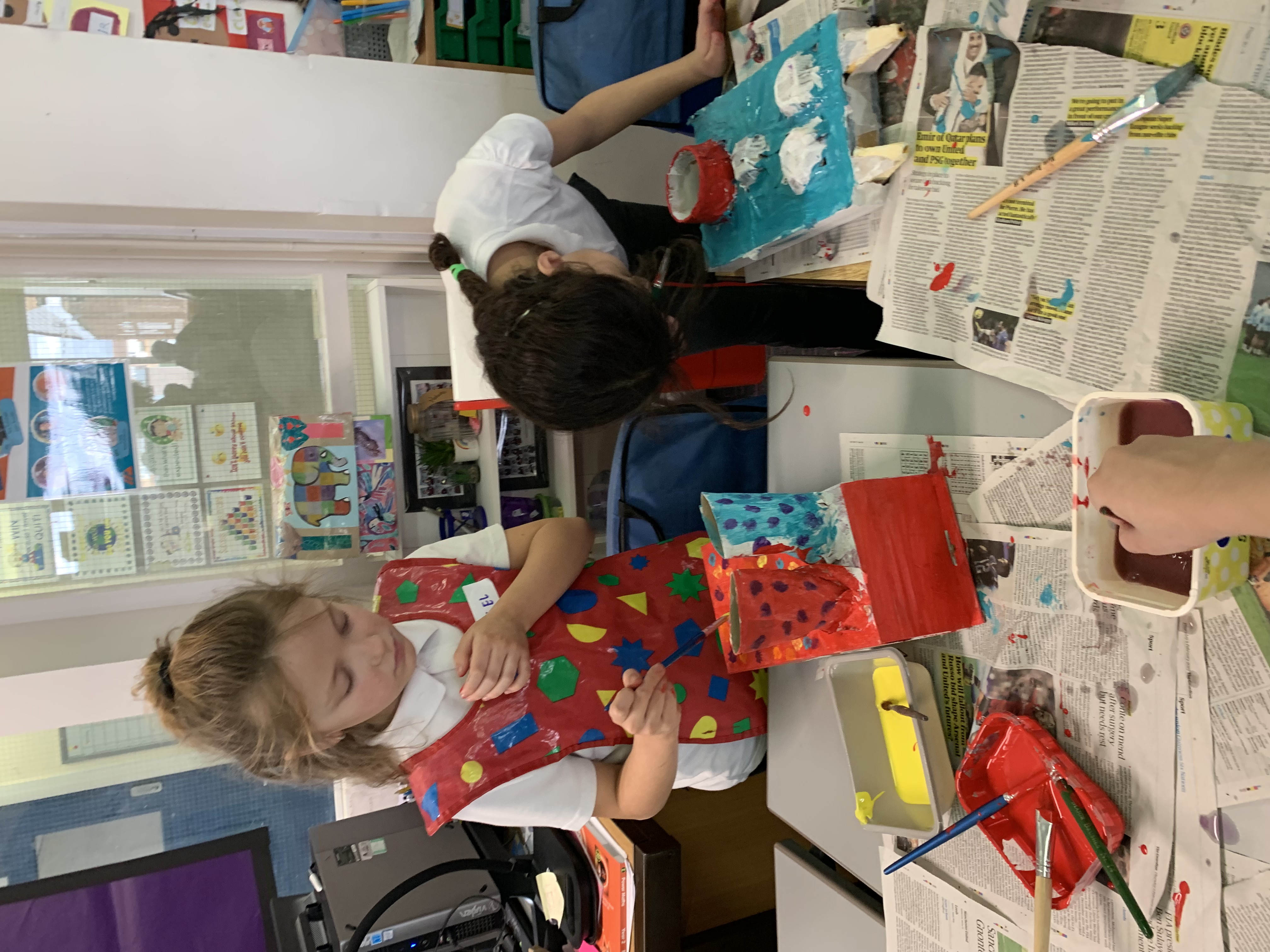 Schoolchildren paint their models