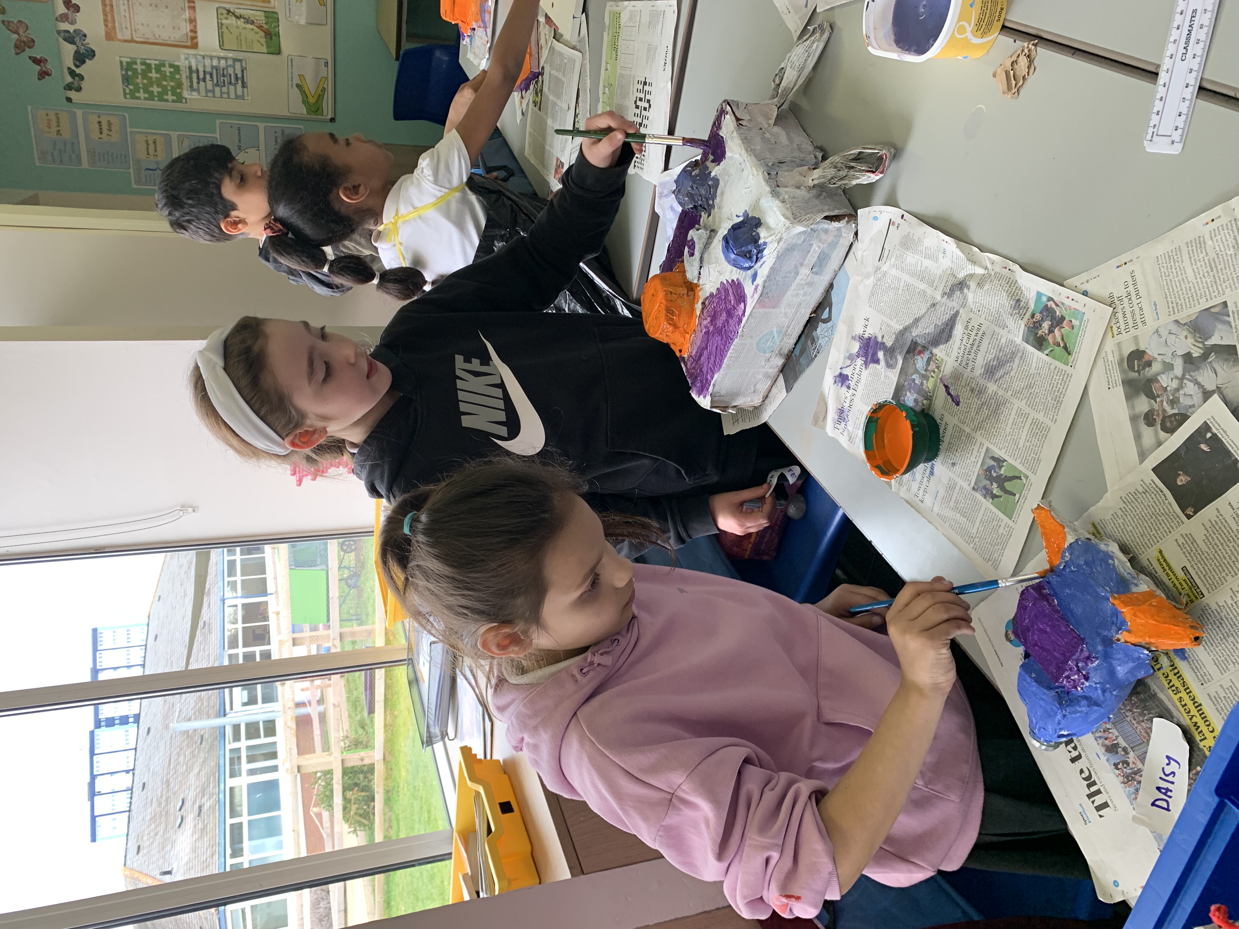 Schoolchildren paint their models