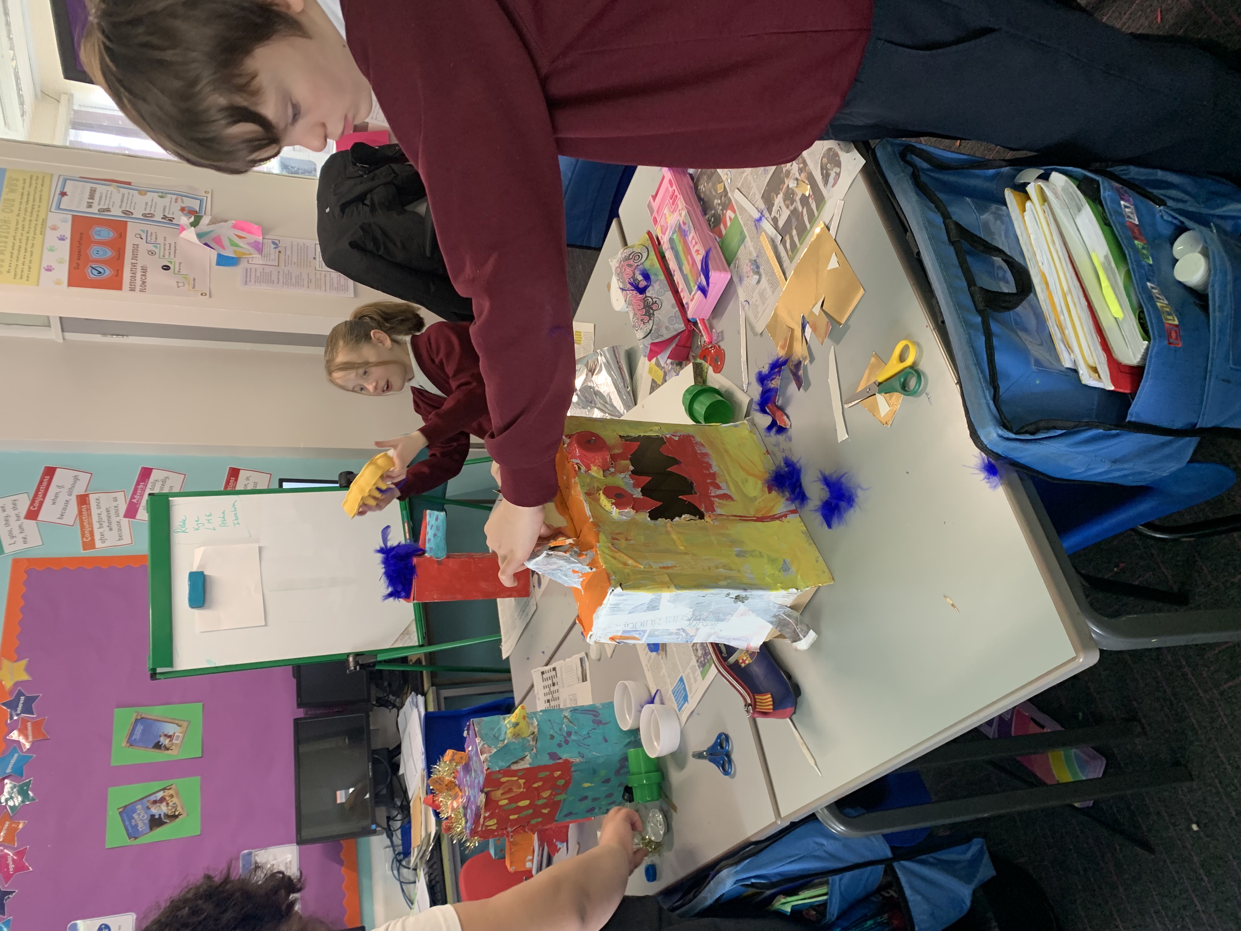 Schoolchildren decorate their paper mache models