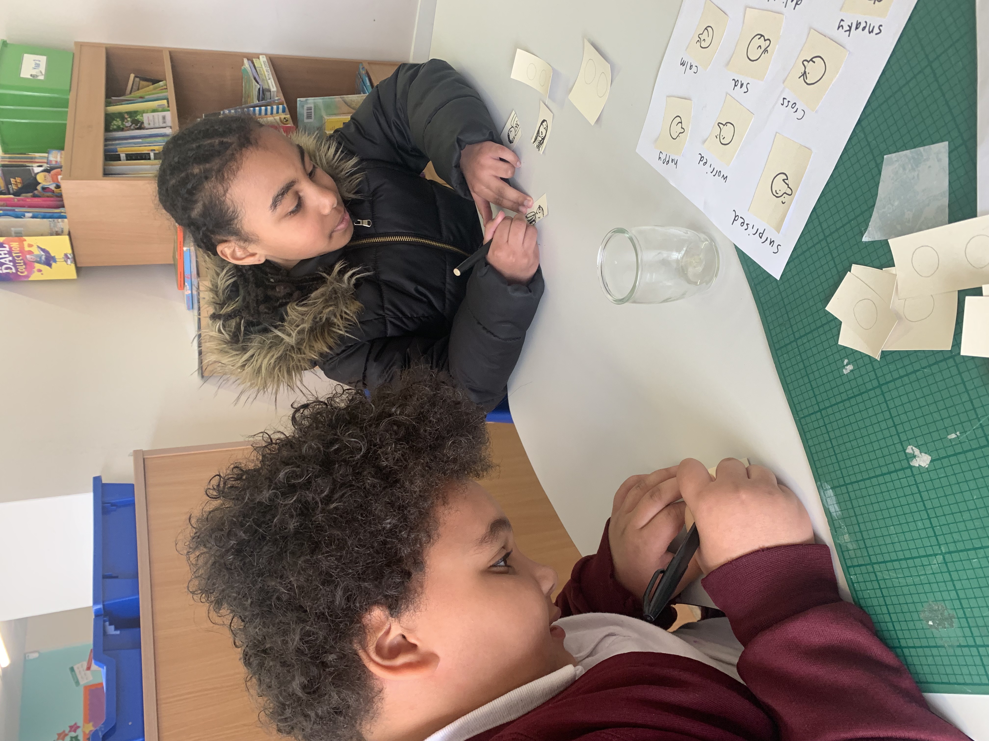 School children drawing people of all ages